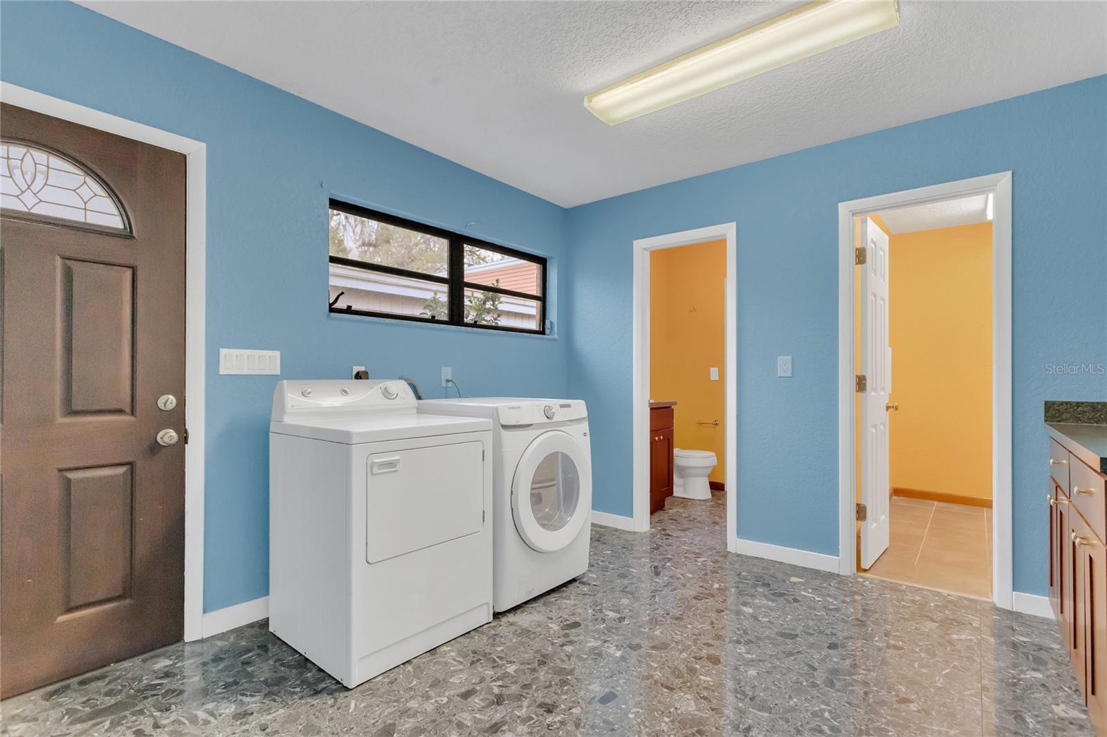 Laundry Room with a full bathroom (including a shower) and also an external door to the lanai