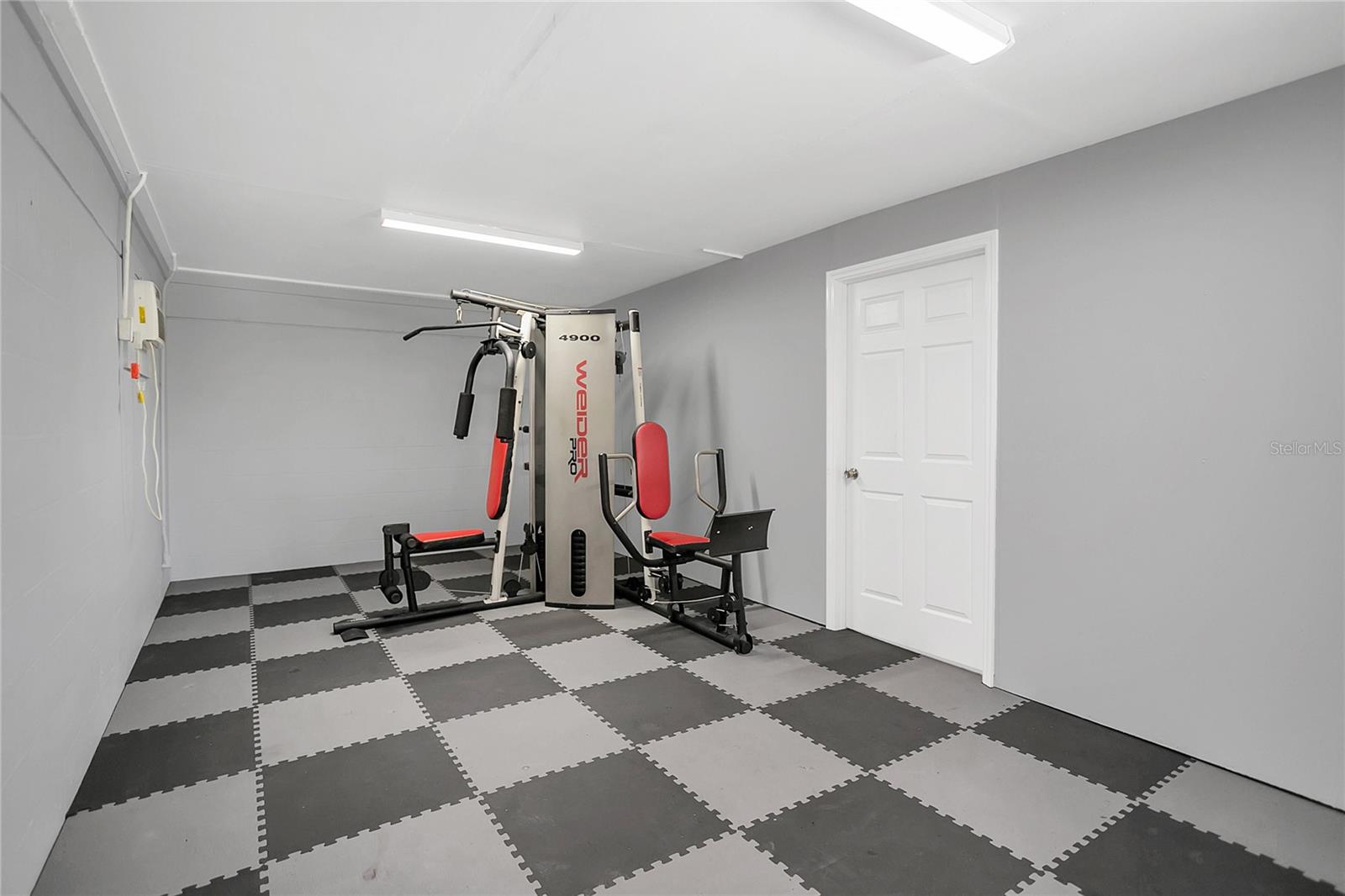 Fitness Room - with a door leading into the garage.