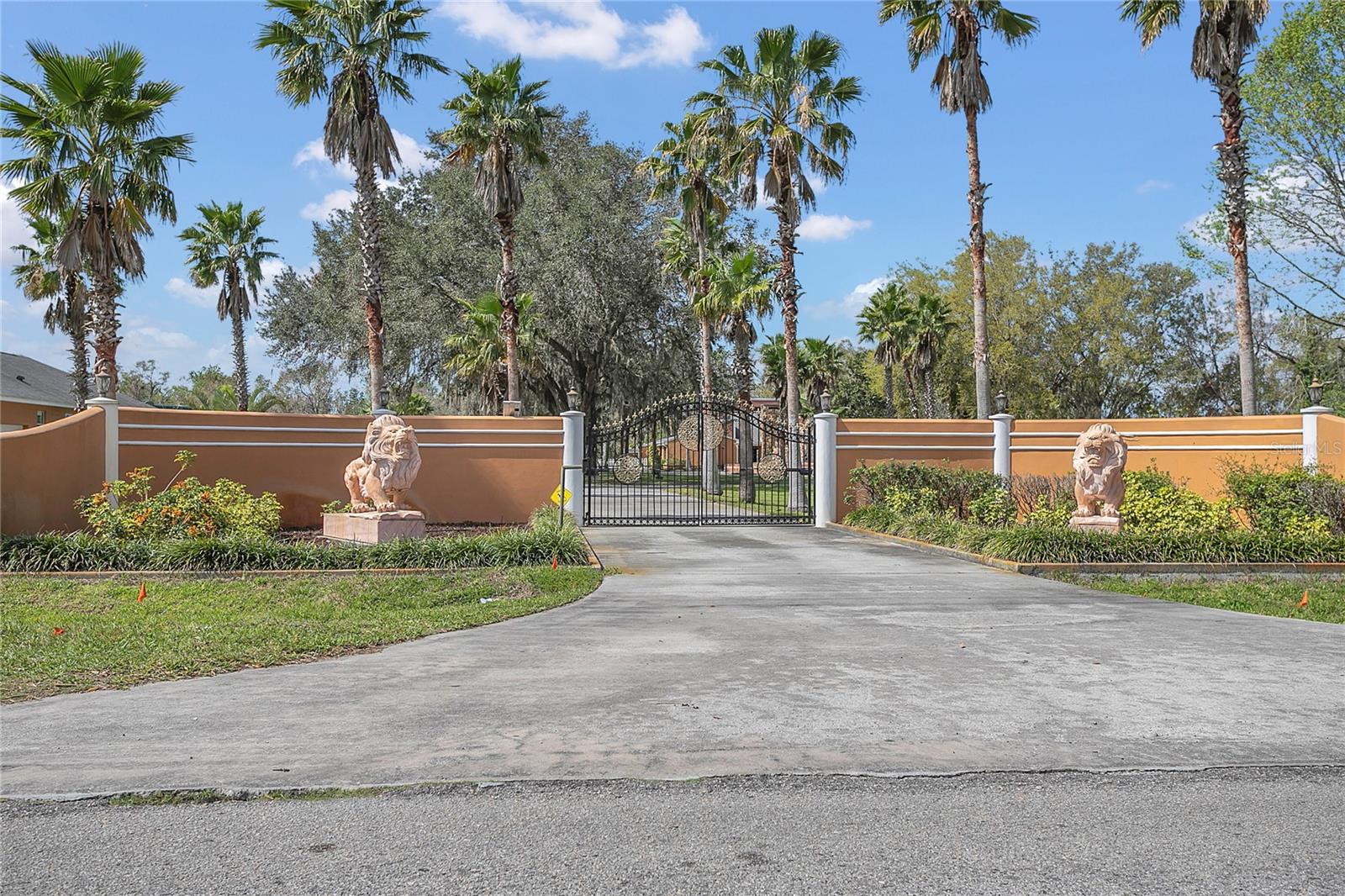 The main entrance to the residence is on Booth Rd and features a manually operated gate, also adorned with lion statues.