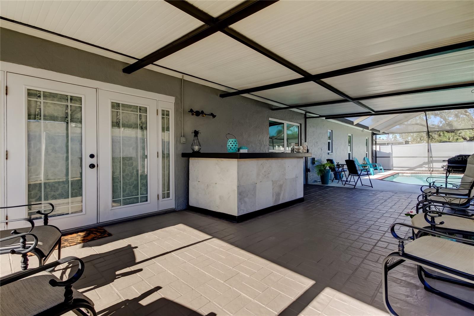 4. A Spacious Lanai, Fully Covered & Screened (24.6' x 14.3) for Grilling Out, Catching Some Shade, Drinks at the Bar... Grab a Chair & Start a Conversation!