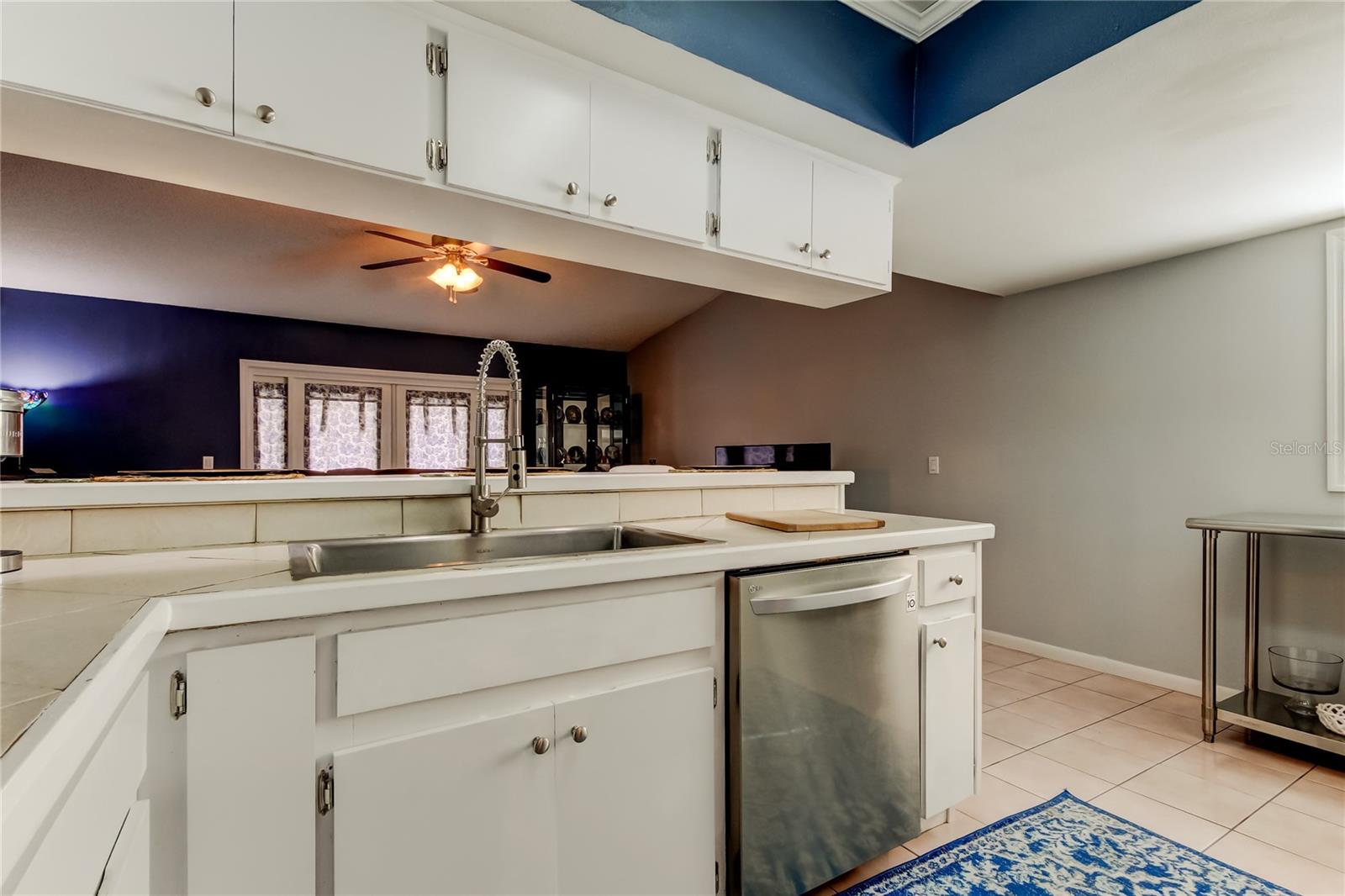 38. Kitchen (13' x 14.10') Overhead Lighting Updated w Splash of tht Beautiful Moody Deep Blue to Create Cohesive Color Theme..