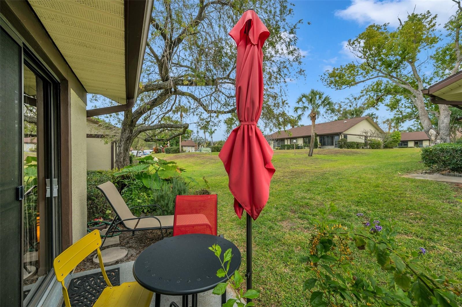 The tranquil back patio is close to the community pool... but not too close!