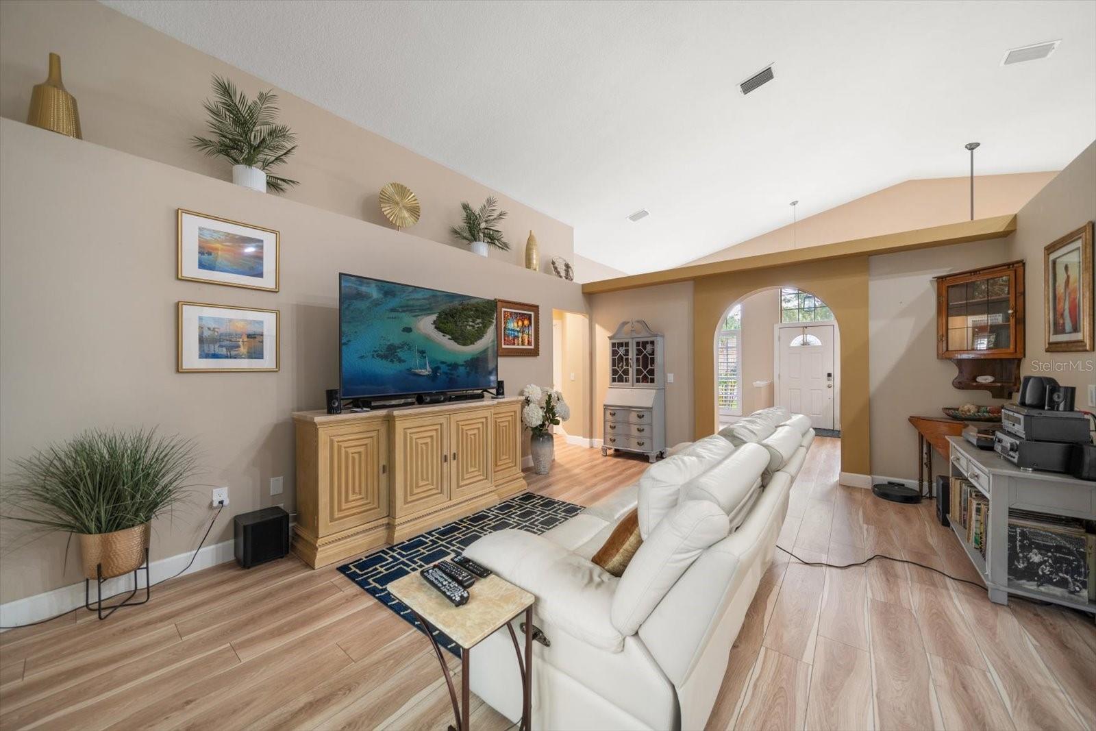 Living room with vaulted ceilings and luxry vinyl plank flooring