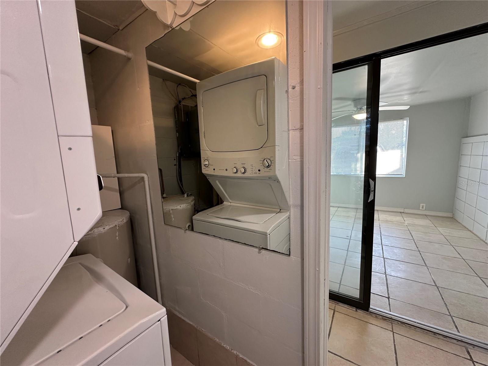 Utility room HWT Mirrored Stackable W/D looking back to the extra room or 3rd bed.