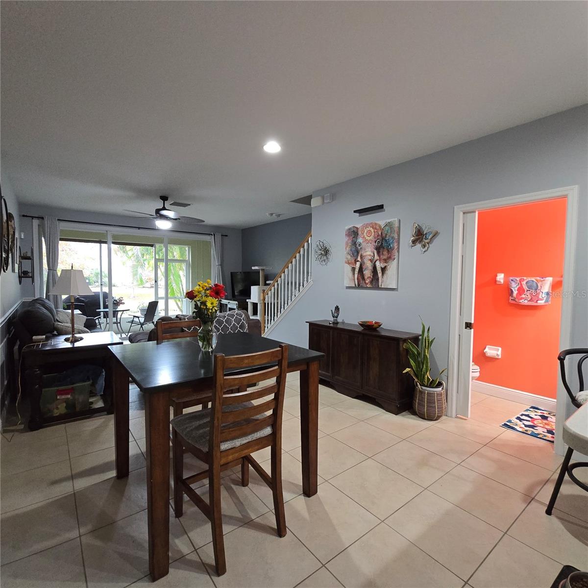 View from breakfast bar towards half bath, dining and screened porch with view of pond