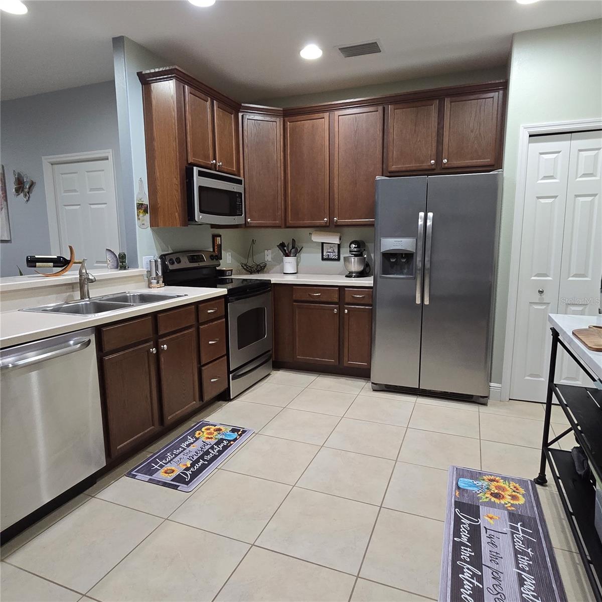 Spacious Kitchen with tall upper cabinets, lots of counter space and a pantry closet