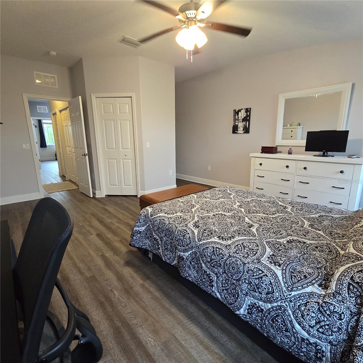 Primary Bedroom view towards hall, walk in closet and ensuite full bathroom