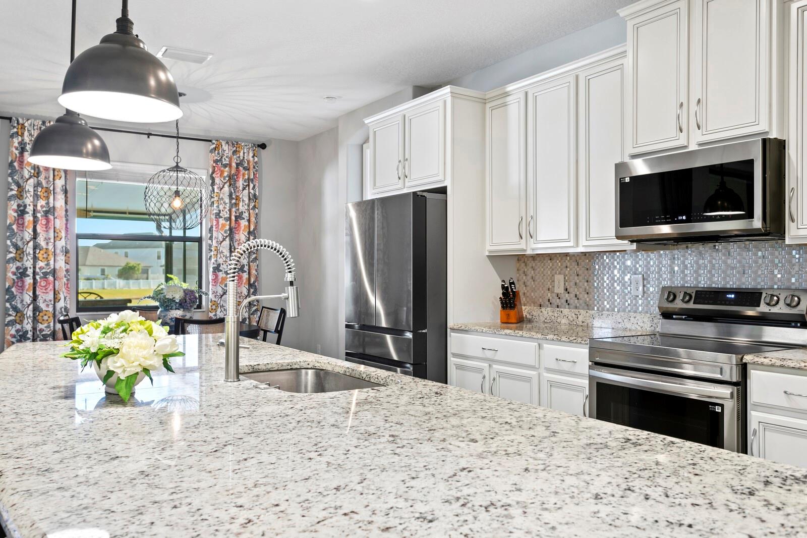 Thick granite counters throughout the kitchen