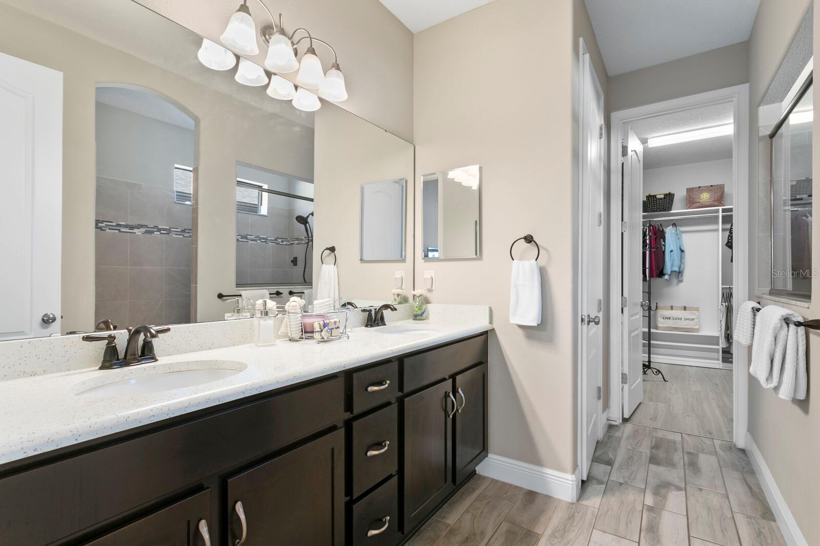 The primary bath featured upgraded cabinets, quartz counters and dual sinks