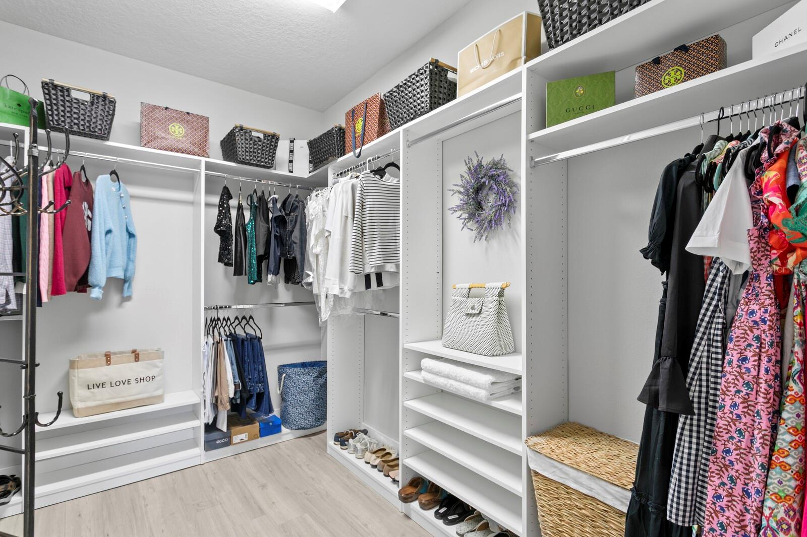 The spacious walk-in-closet with custom organizer in the primary suite