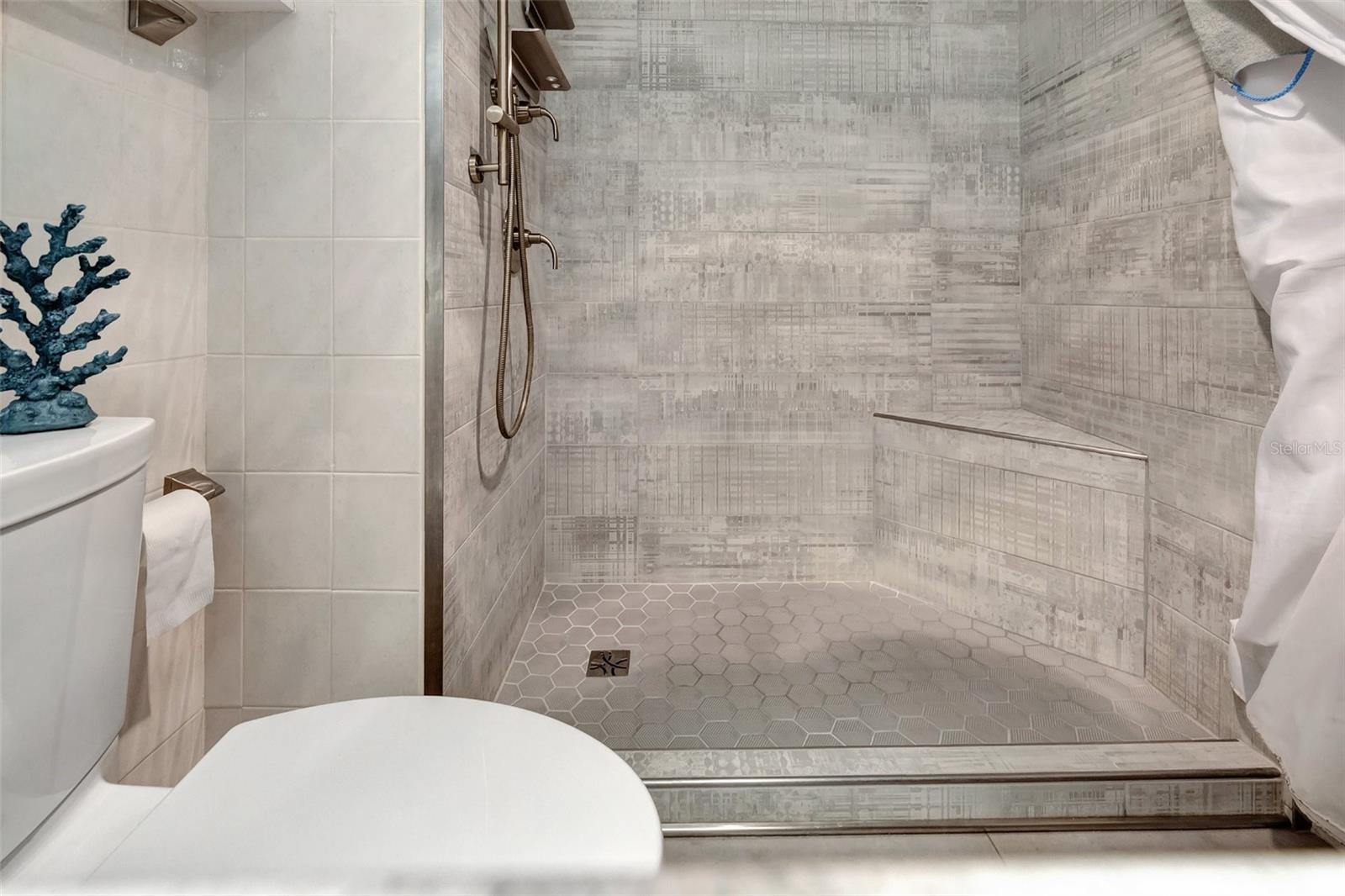 A Large walk in Shower with built in bench for your convienence.