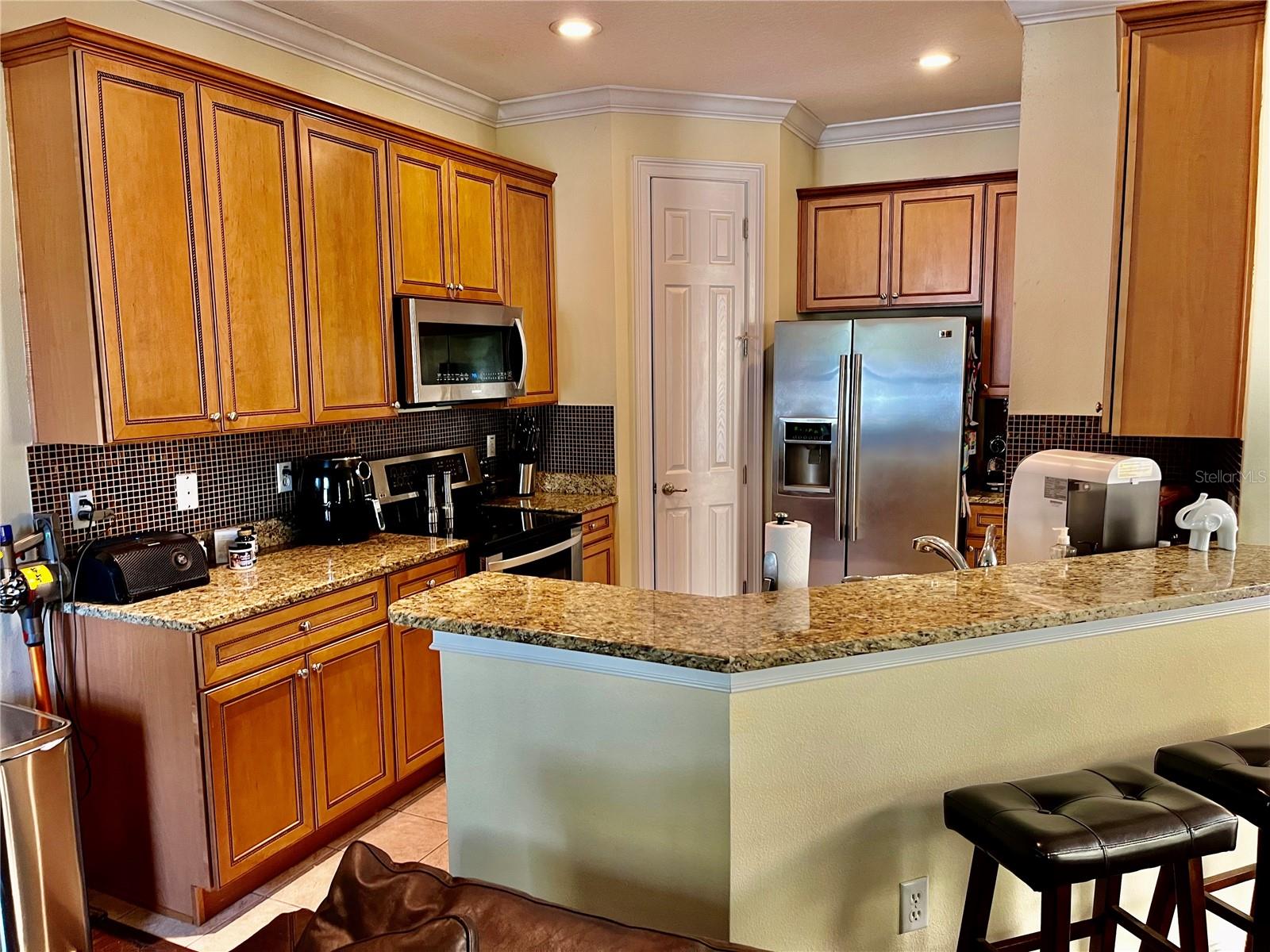 Kitchen features high end appliances, solid wood maple cabinets