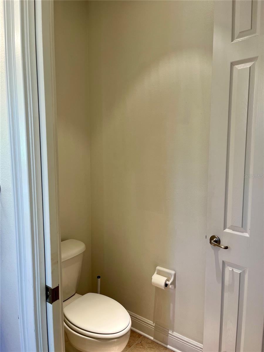Water closet with linen closet and pocket door