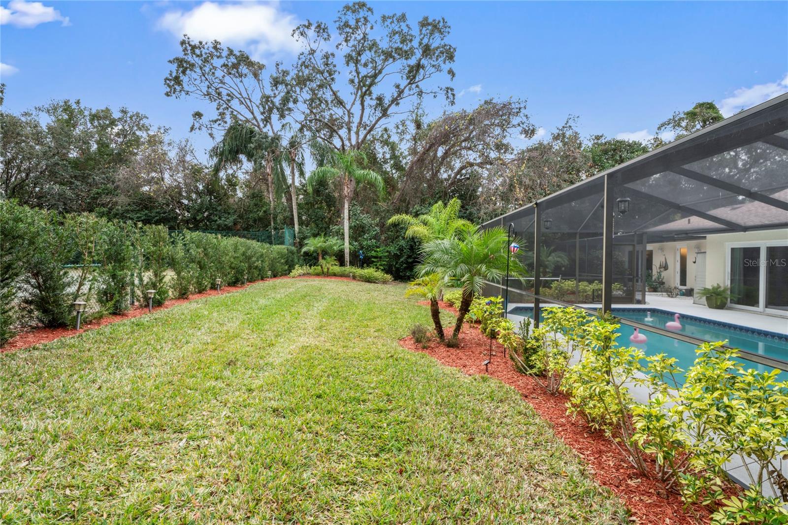 Backyard with Tennis Court behind Hedge