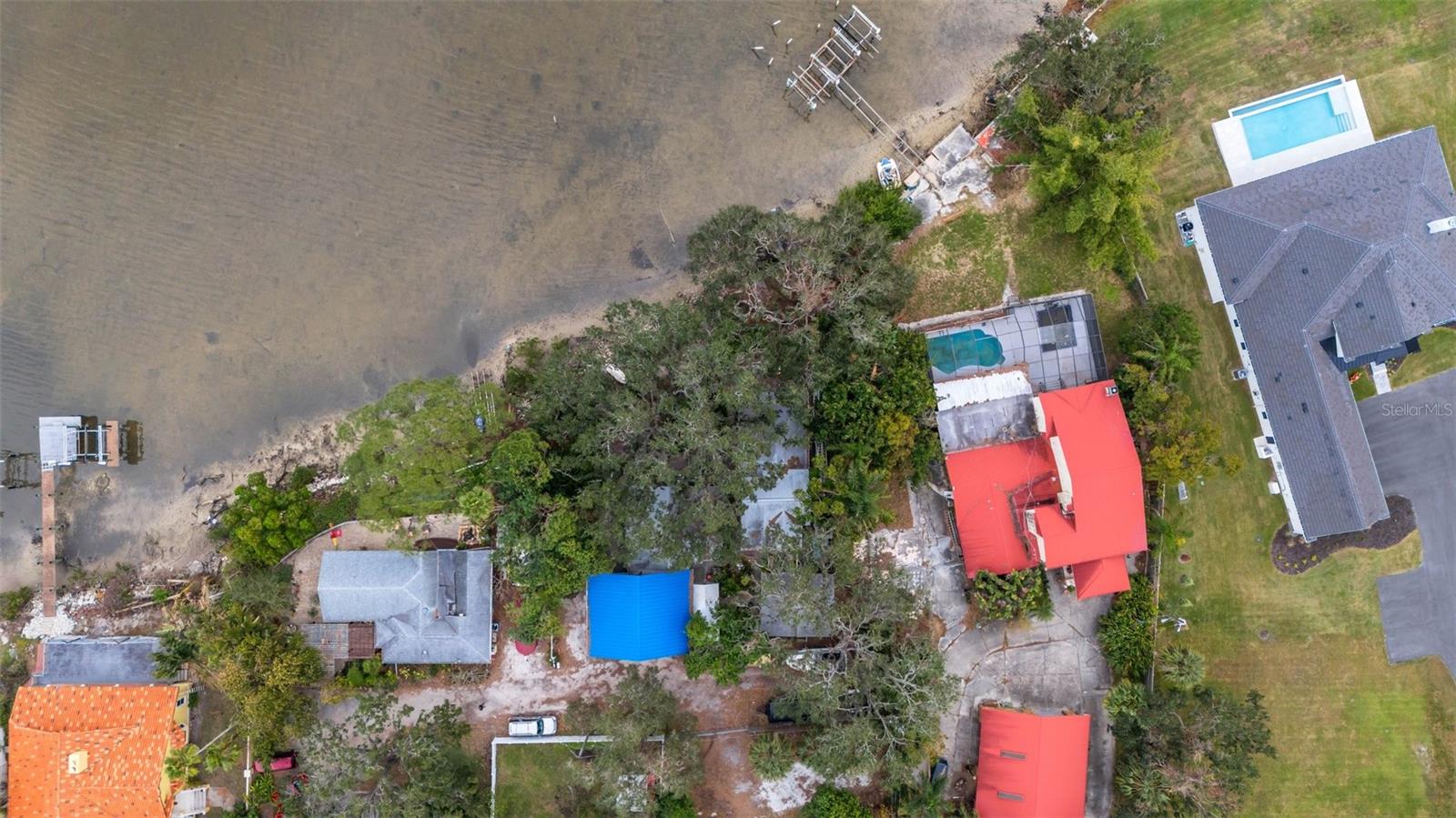 garage=blue roof, houses under tree cover