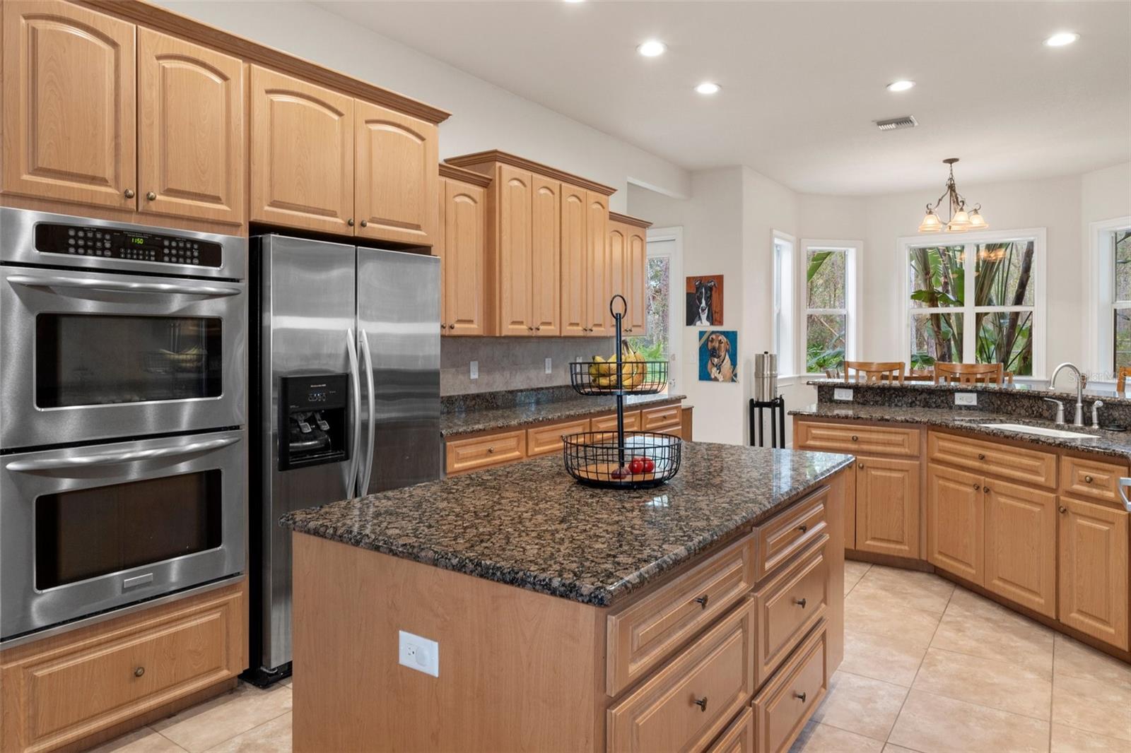 Kitchen island and double wall convection ovens.