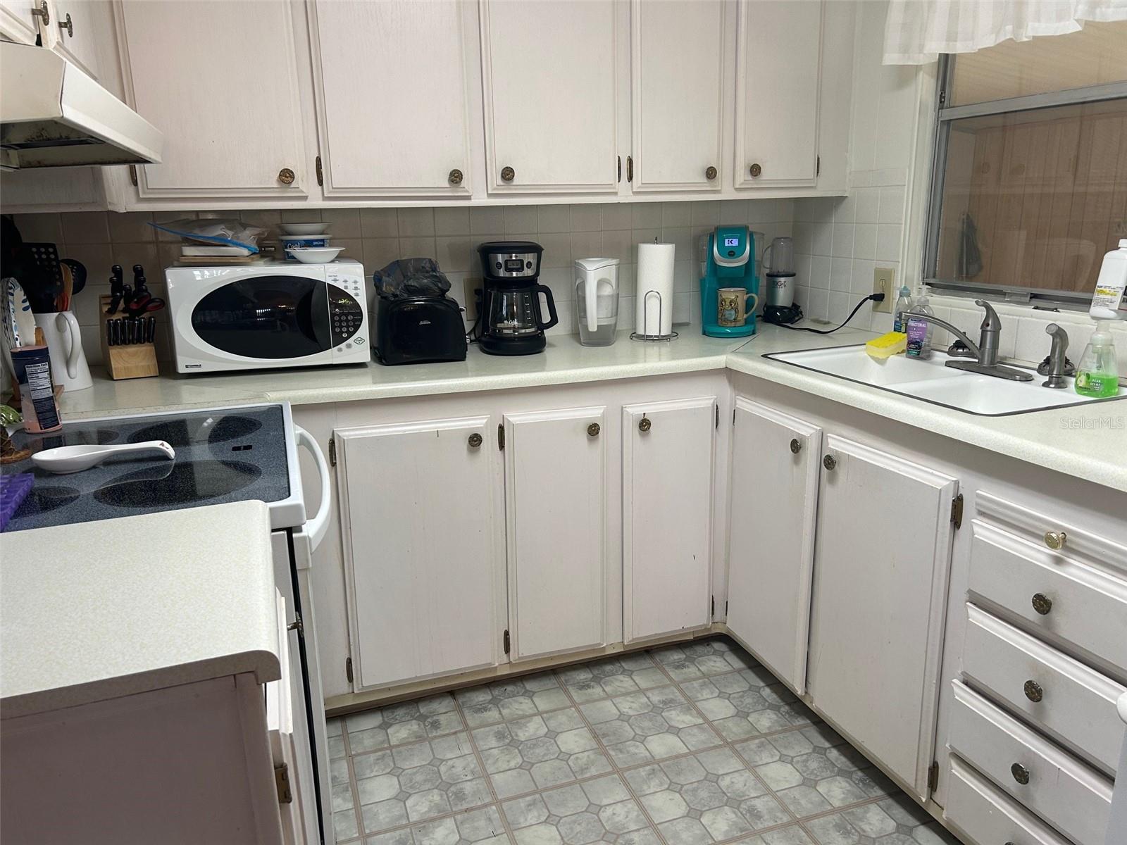 Light and bright kitchen with glass top stove