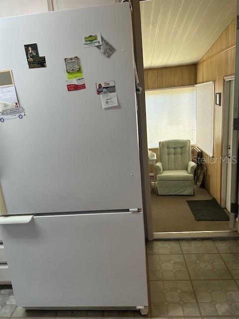 Large refrigerator and partial view of Florida room.