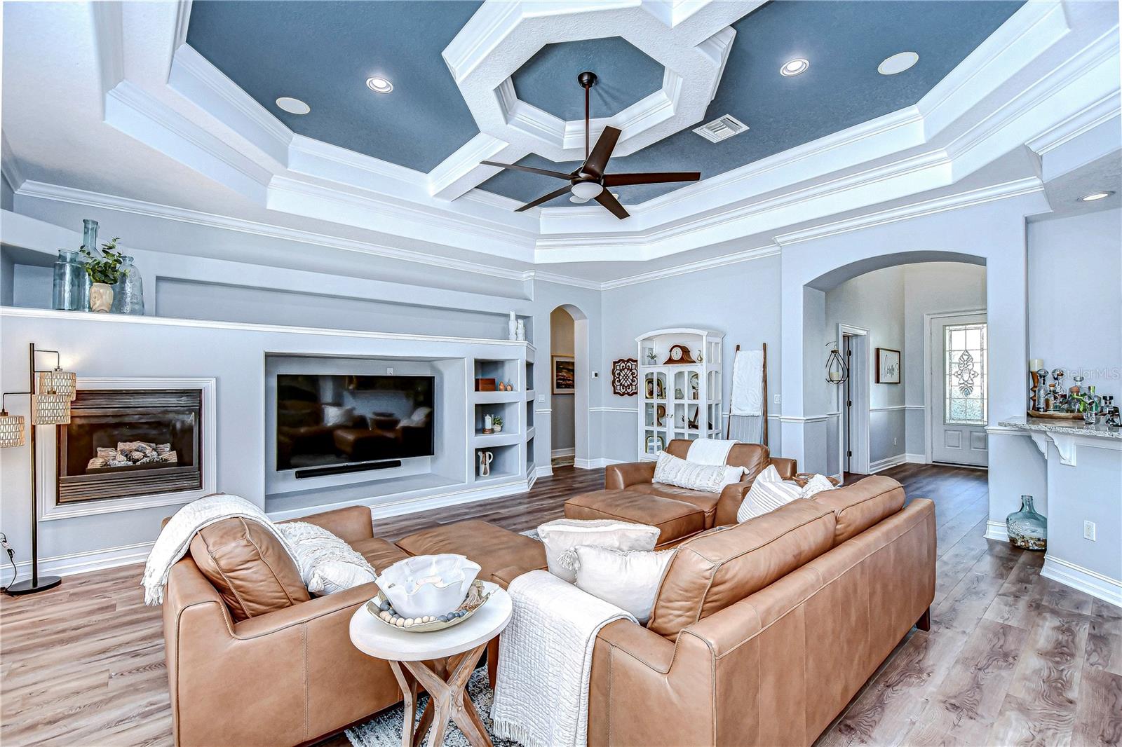 Elegant moldings and vaulted ceilings create a spacious and grand great room.