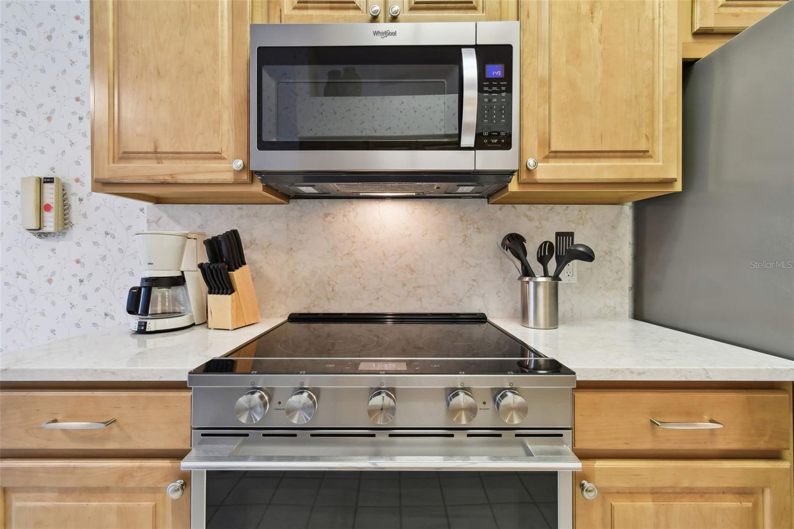 Beautiful range with granite counter tops and full granite back splashes - Easy maintenance while preparing meals