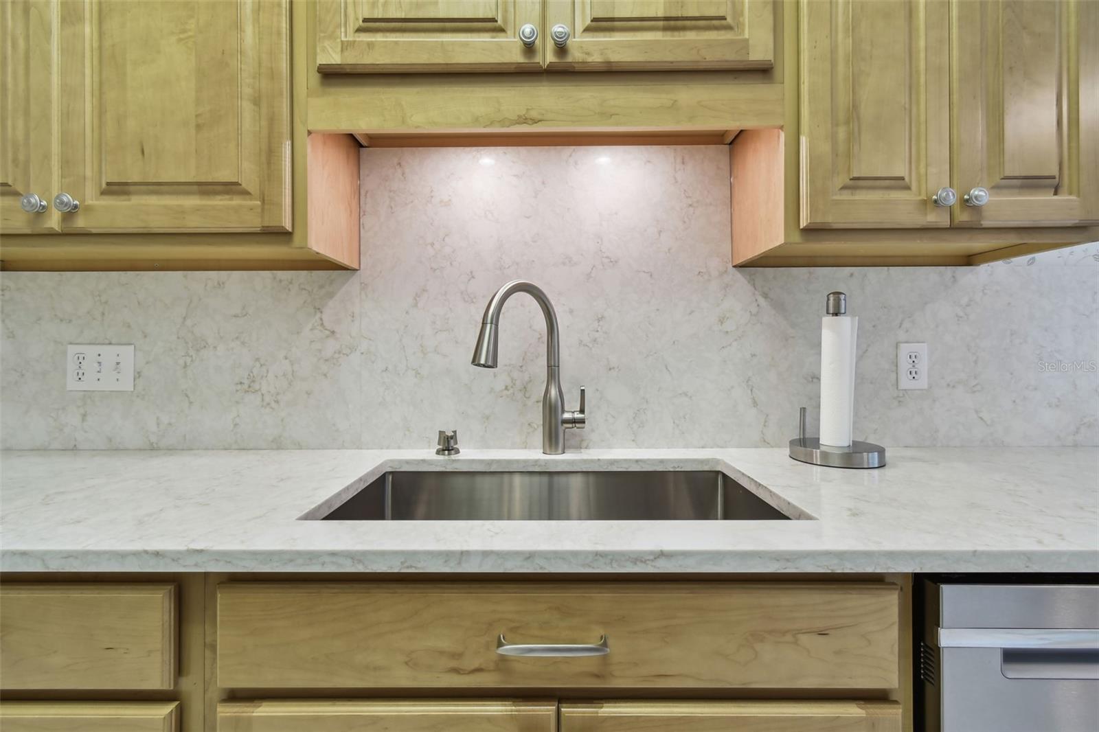 Under mount stainless steel sink with lighting.