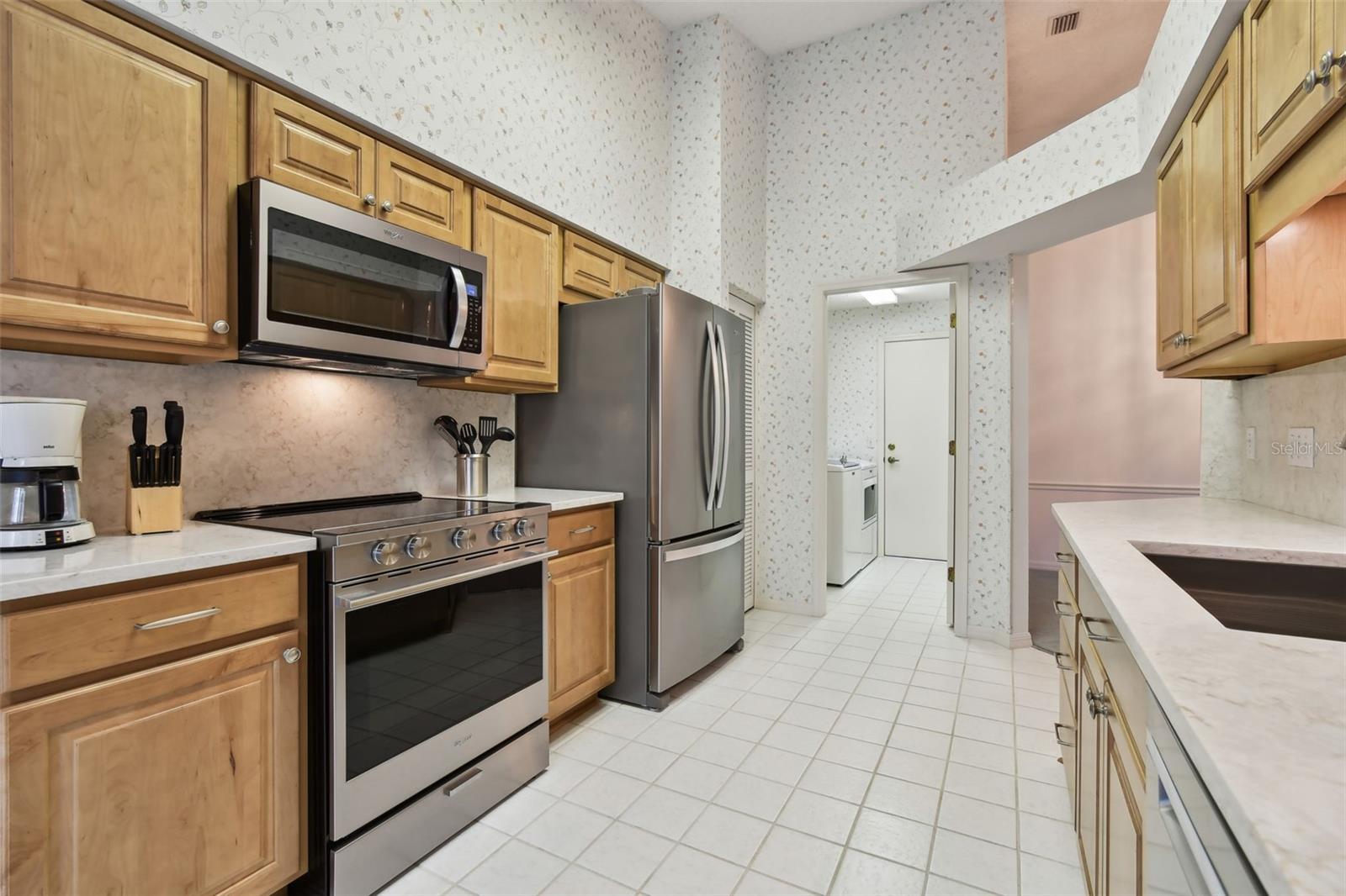 Kitchen facing laundry room and garage