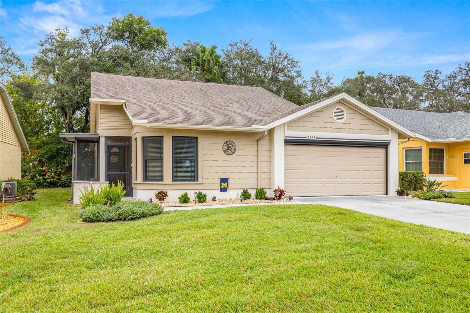 Freshly landscaped with a large 2 car garage with storage, as well as a remote roll-up Garage Screen Door too!