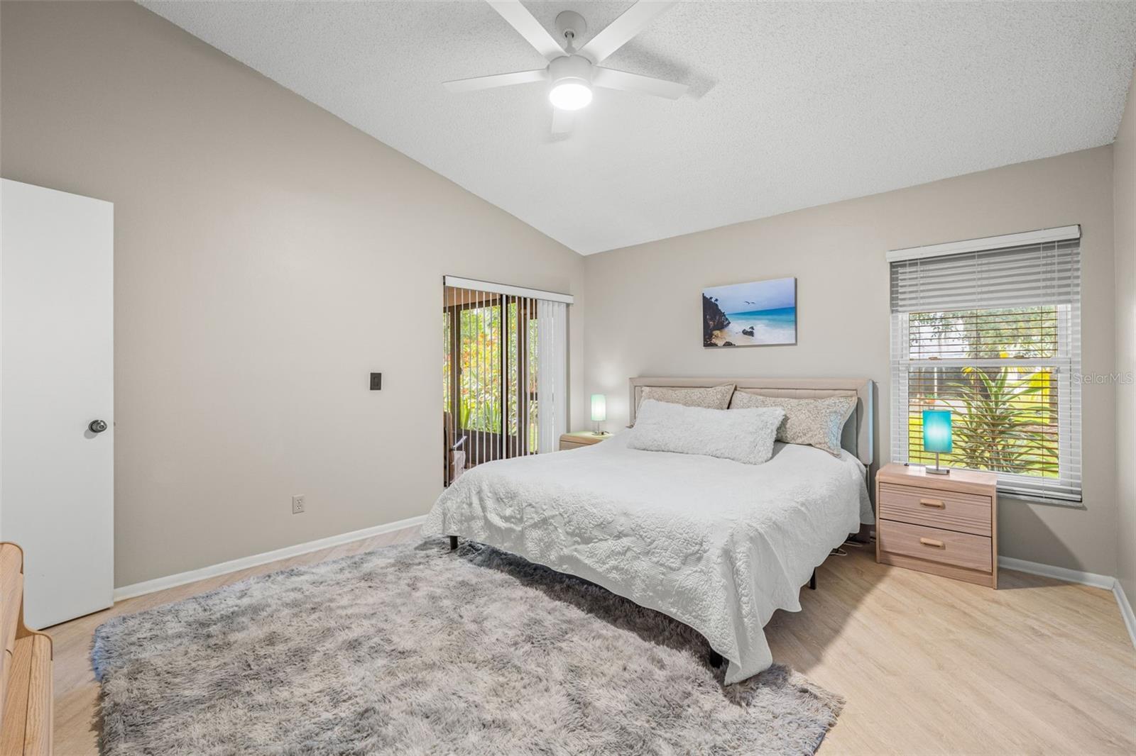 Another view of primary bedroom toward sliding doors which lead to the lanai.