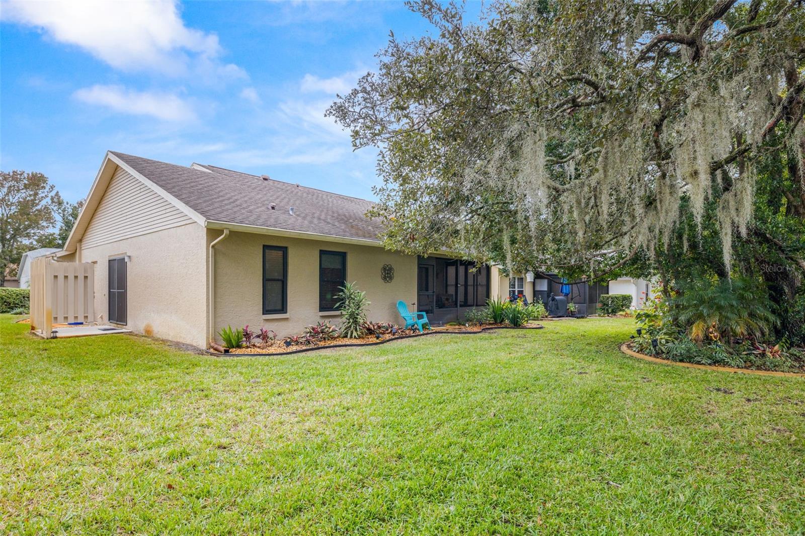 Another view toward the home from the back.  Notice the side patio, which is off the kitchen...perfect for that BBQ!