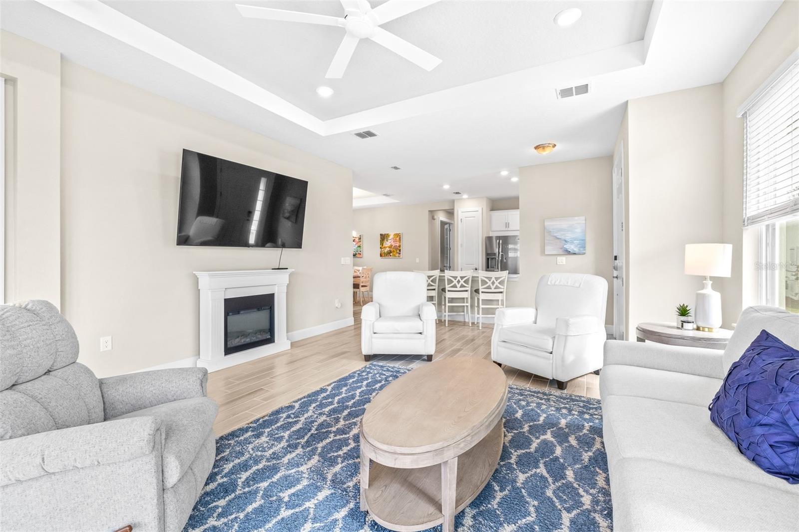 Bright Spacious Living Area with Tray Ceilings