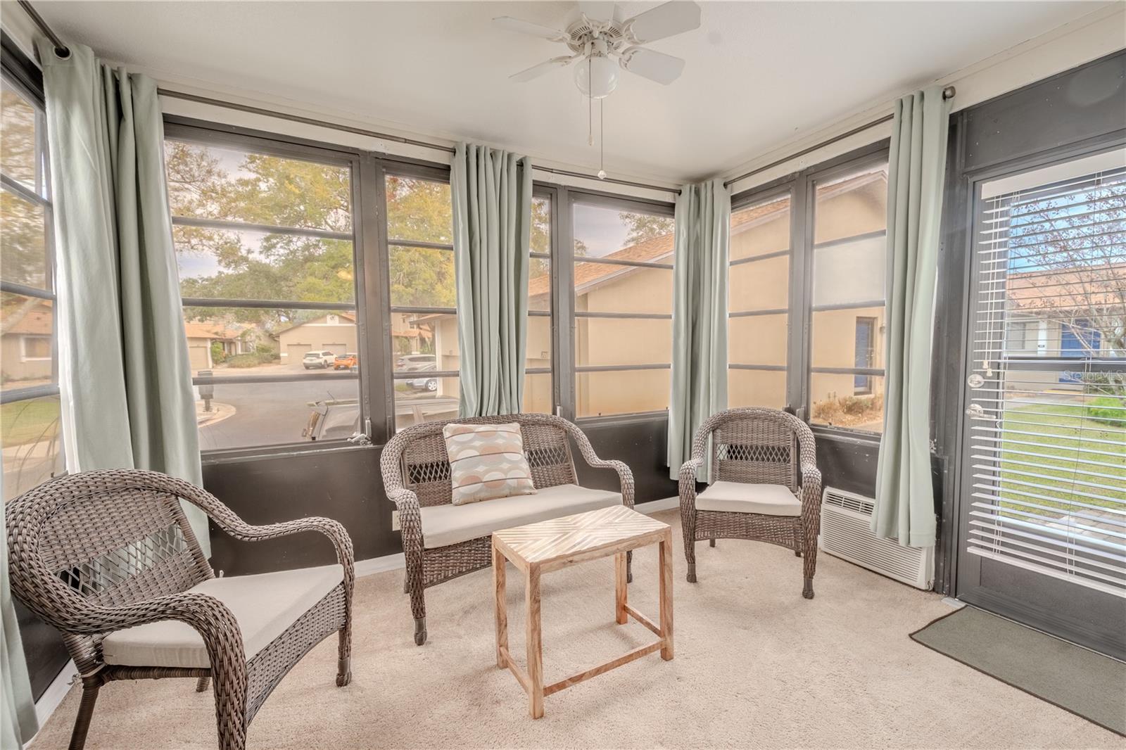 The cozy enclosed lanai/Florida room is ideal for relaxing, morning coffee and reading a good book.