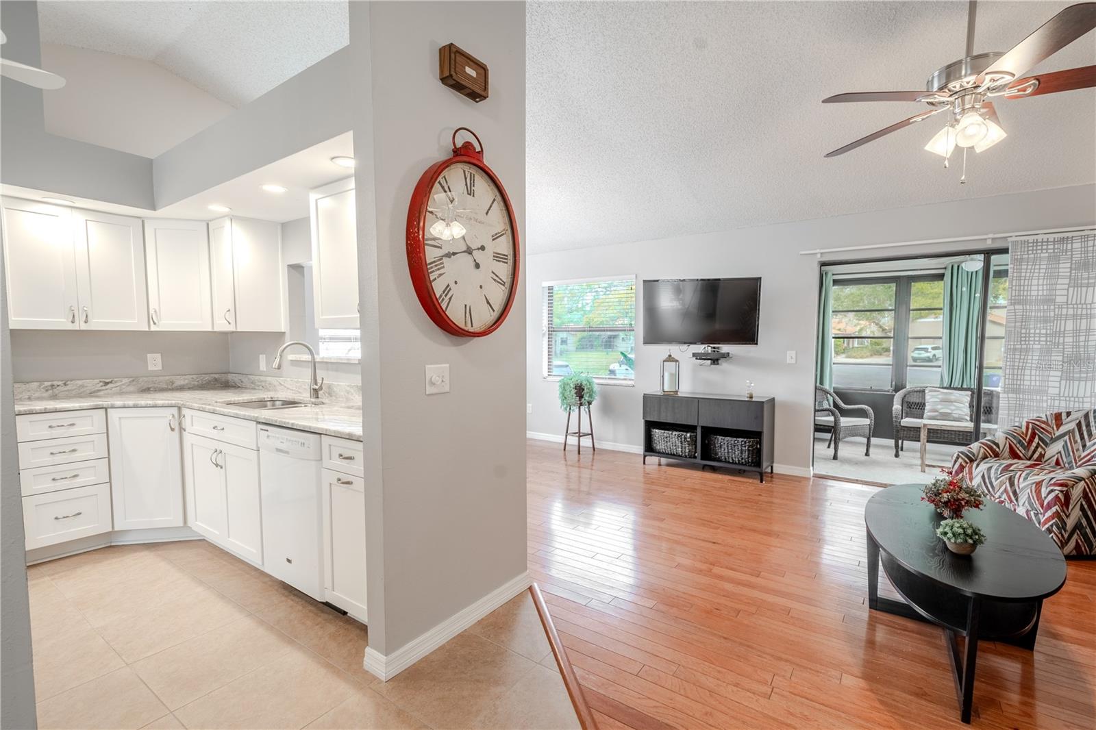 The kitchen is to the left of the foyer and features a vaulted ceiling.