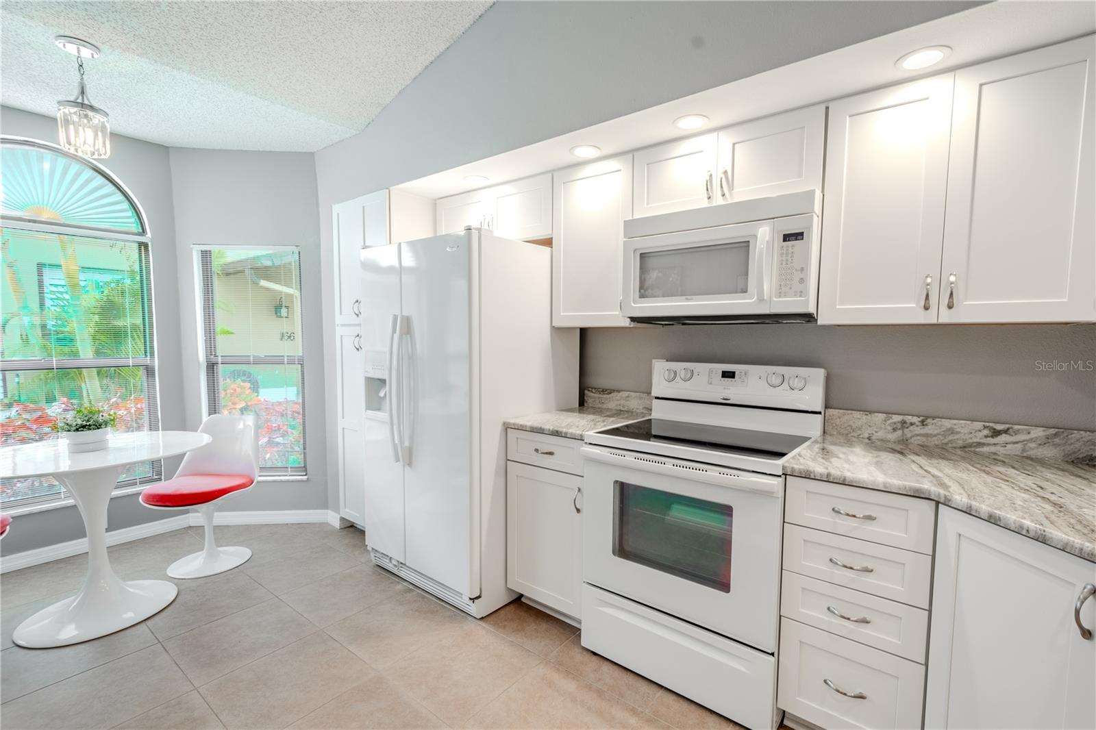 The kitchen has room for your breakfast table infront of this lovely bay window.