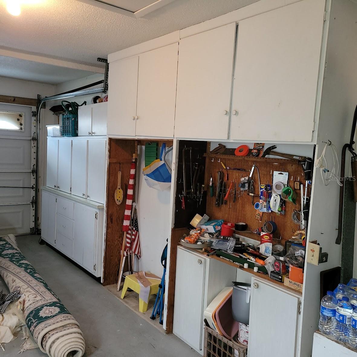 The garage has many cabinets for additional storage.