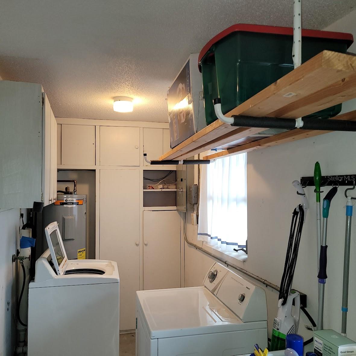 The washer, Dryer, new water heater, Electric Panel and more storage.