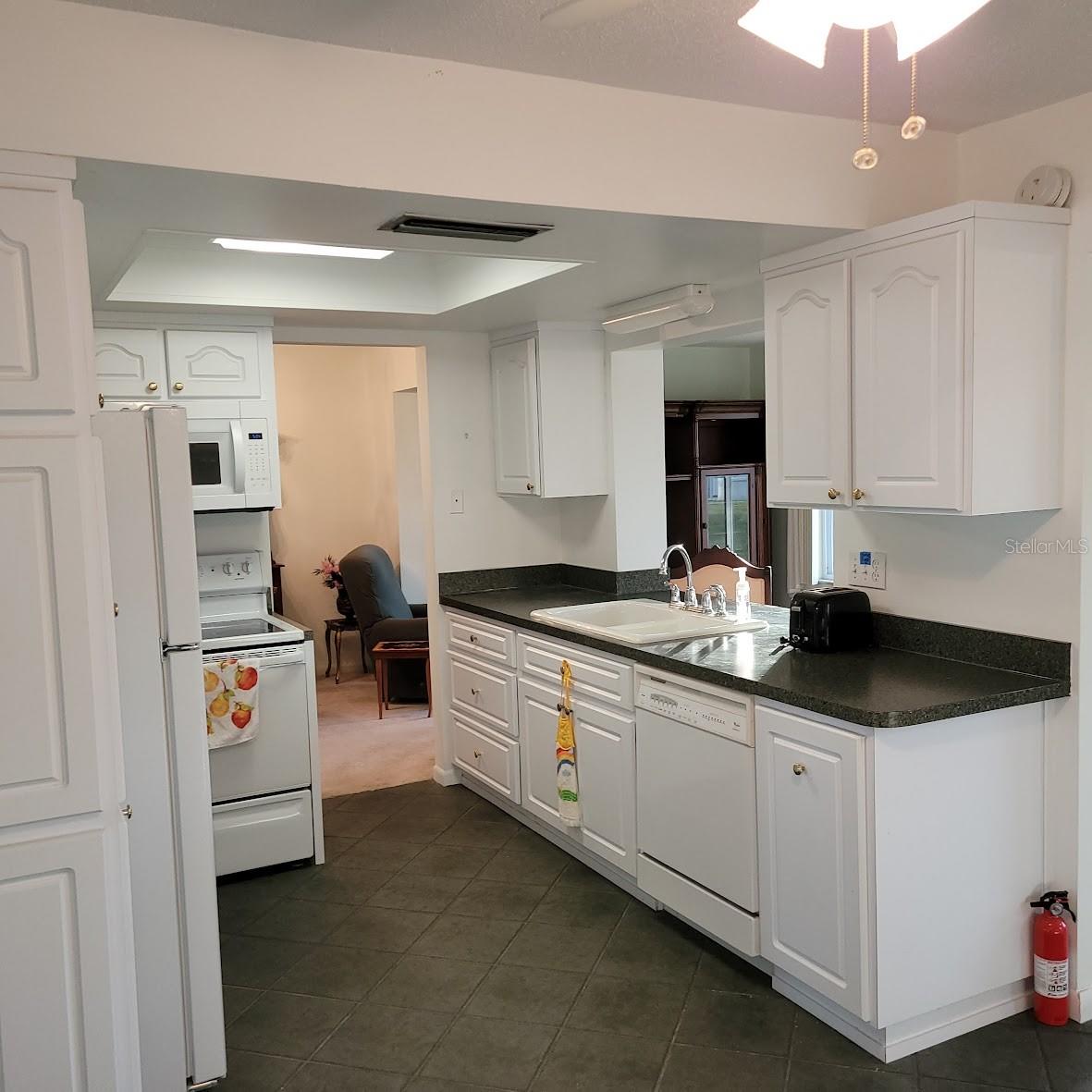 The kitchen sink and passthrough in the kitchen allows for conversations with others in the dining and family rooms.