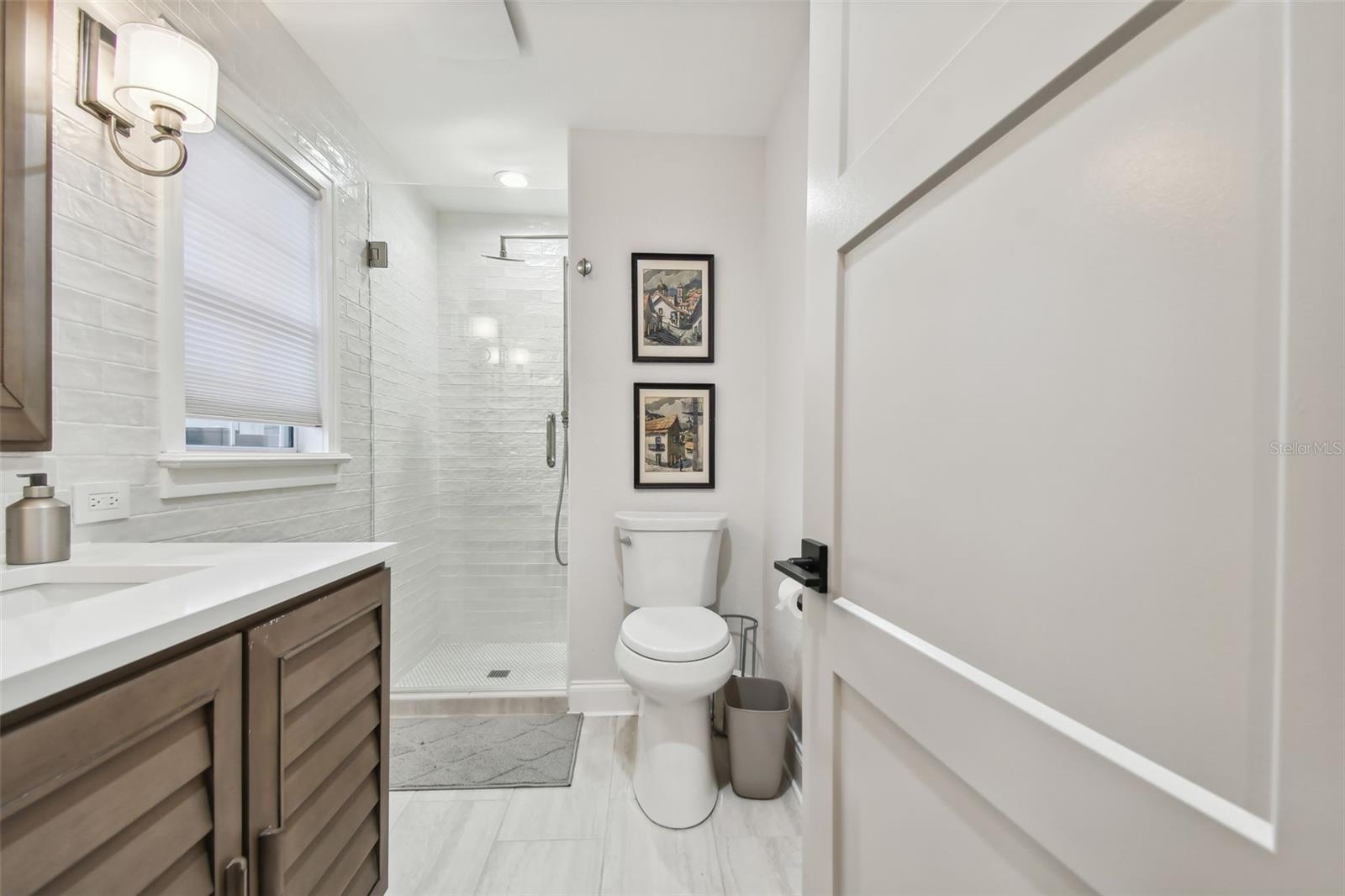 Newly renovated en-suite bath for downstairs bedroom being used as a TV/Den