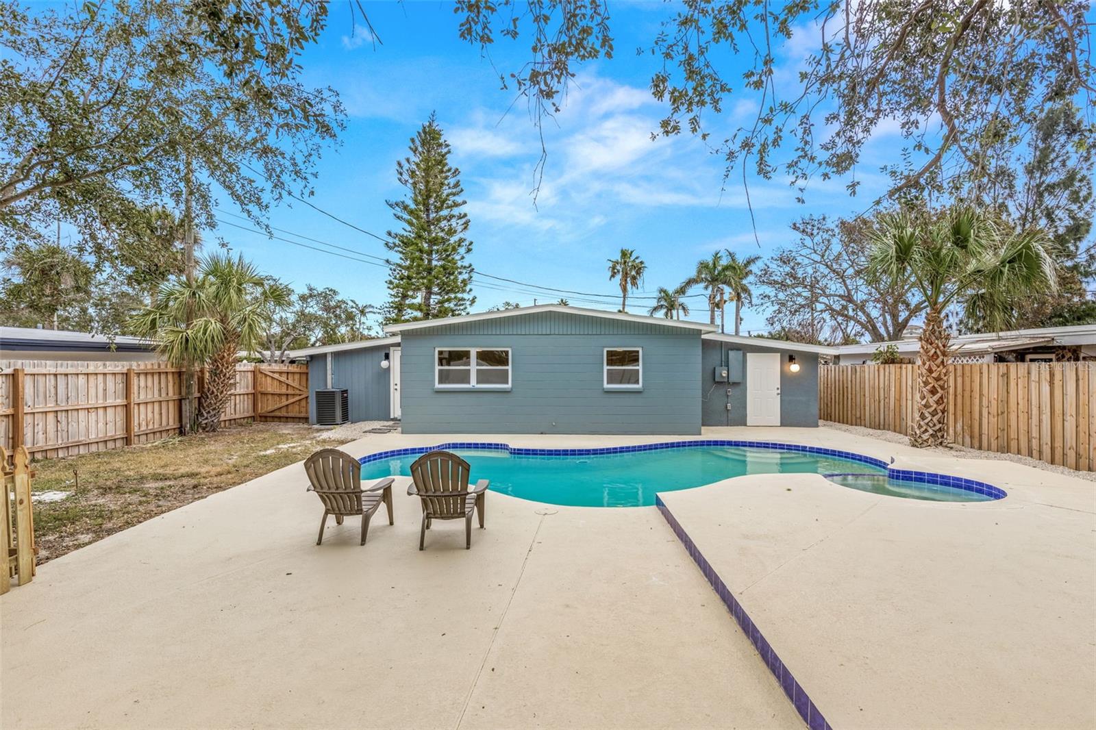 Large backyard patio with pool and spa