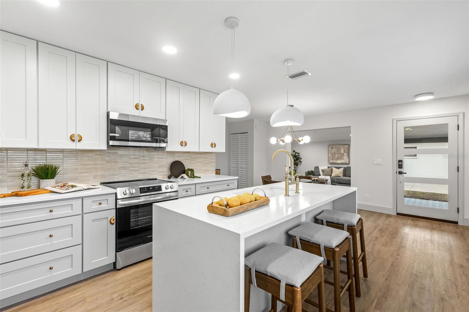 Center island with Quartz waterfall edges and breakfast bar