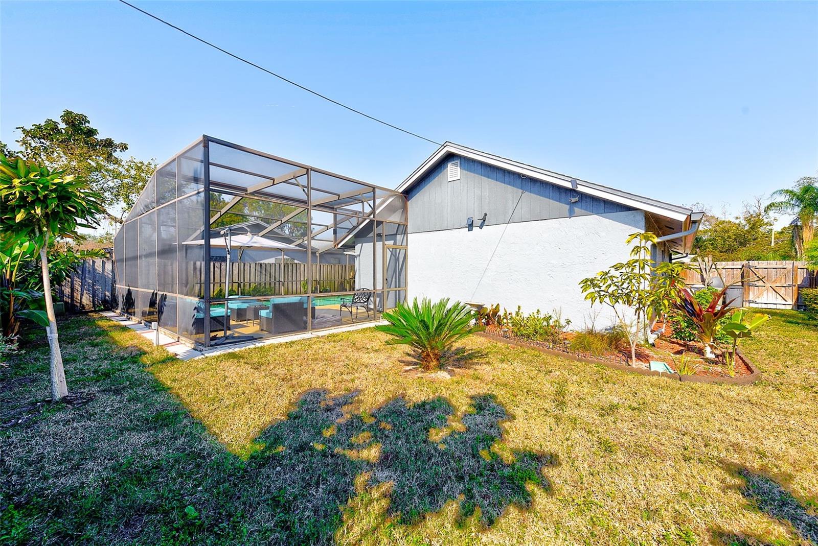 View of back of home and fenced yard