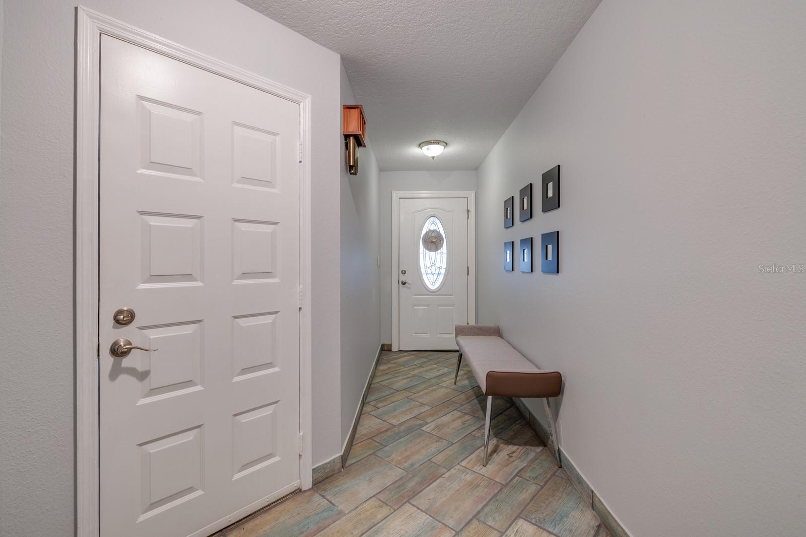 2 car garage entrance and front door entrance to foyer.