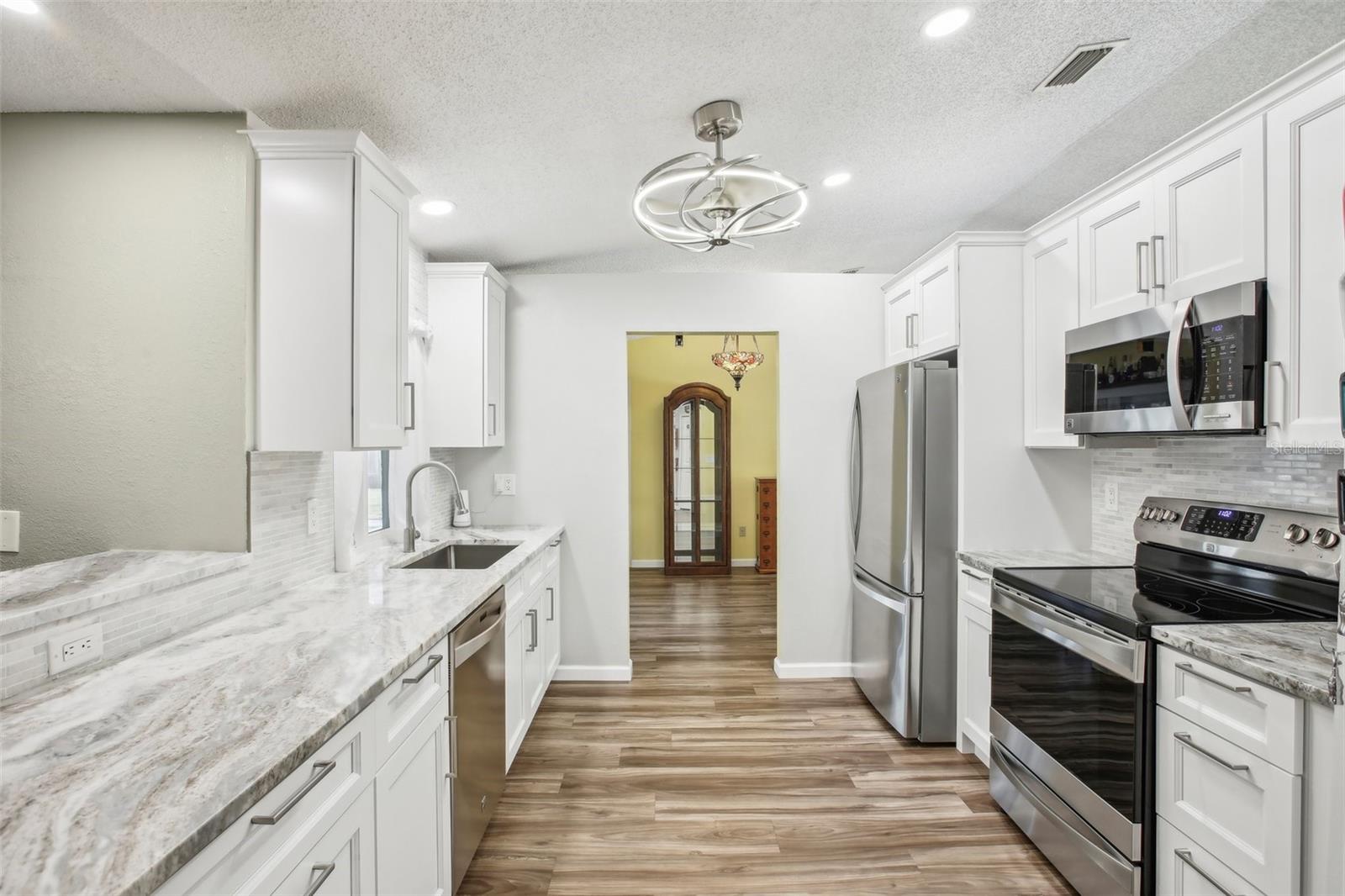 Quartz counter tops, high quality brushed nickel ceiling fan, and matching stainless steel appliances!