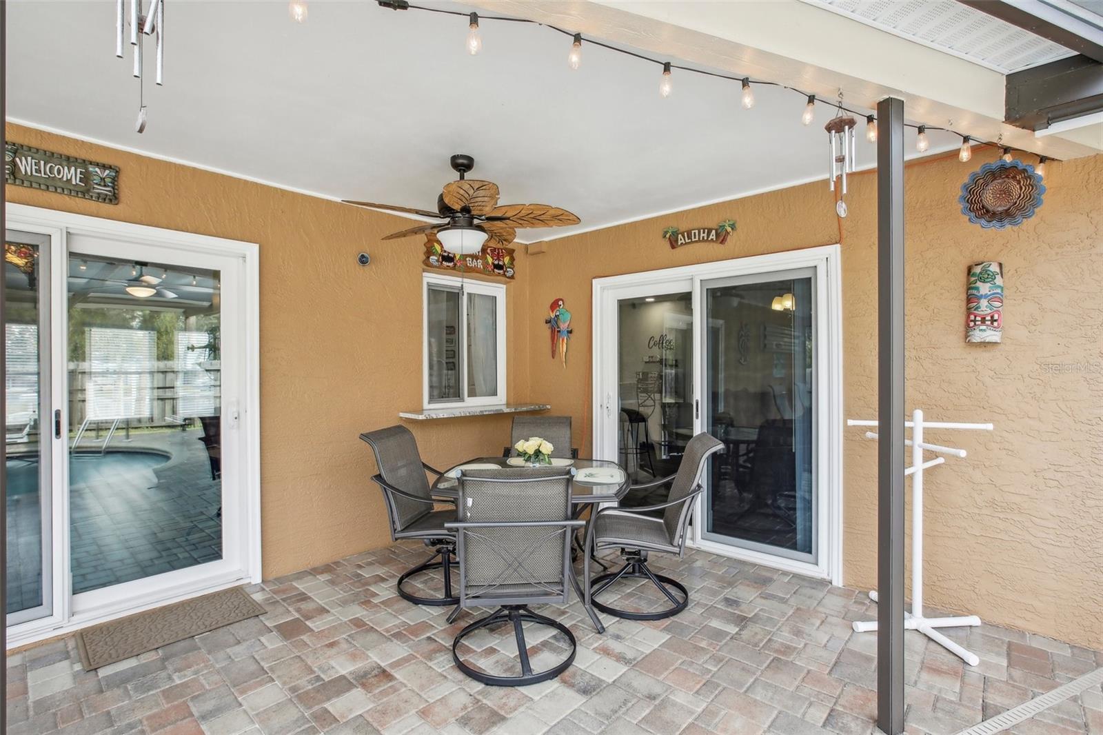 Outside Dining area with new ceiling fan overlooking your amazing pool area!