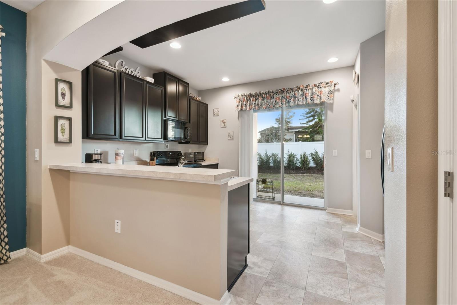 Kitchen view and sliders out to the backyard.