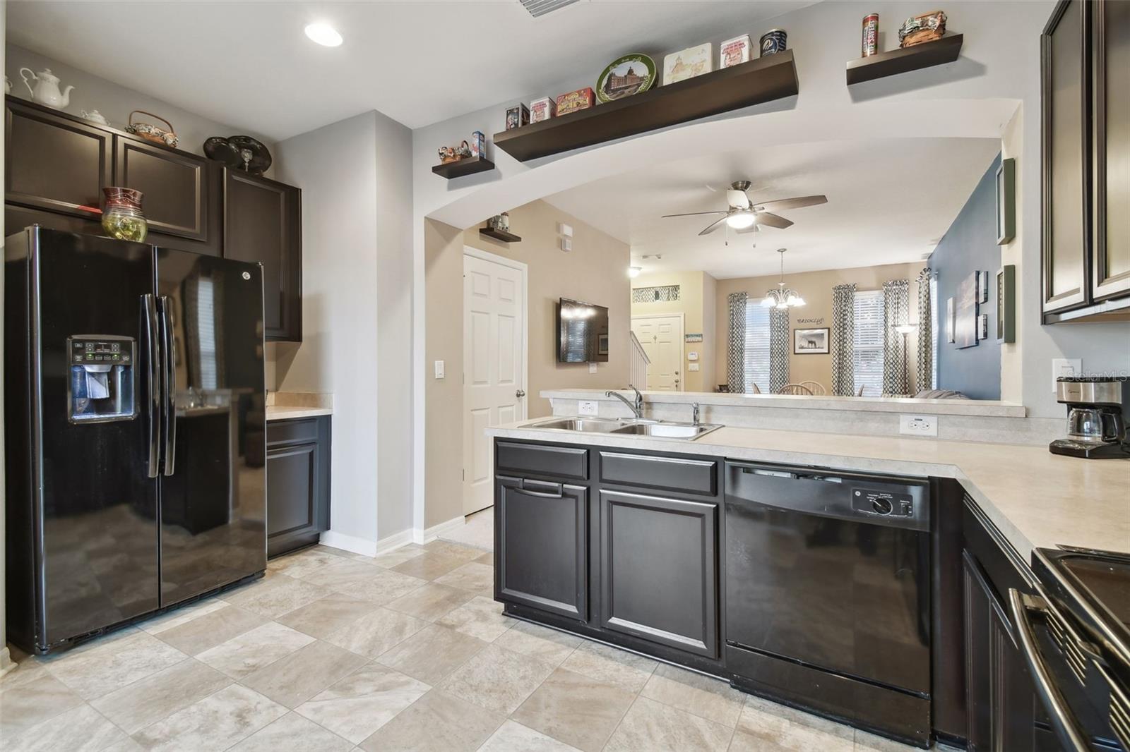 Open and bright kitchen with ample cabinetry and good sized pantry.