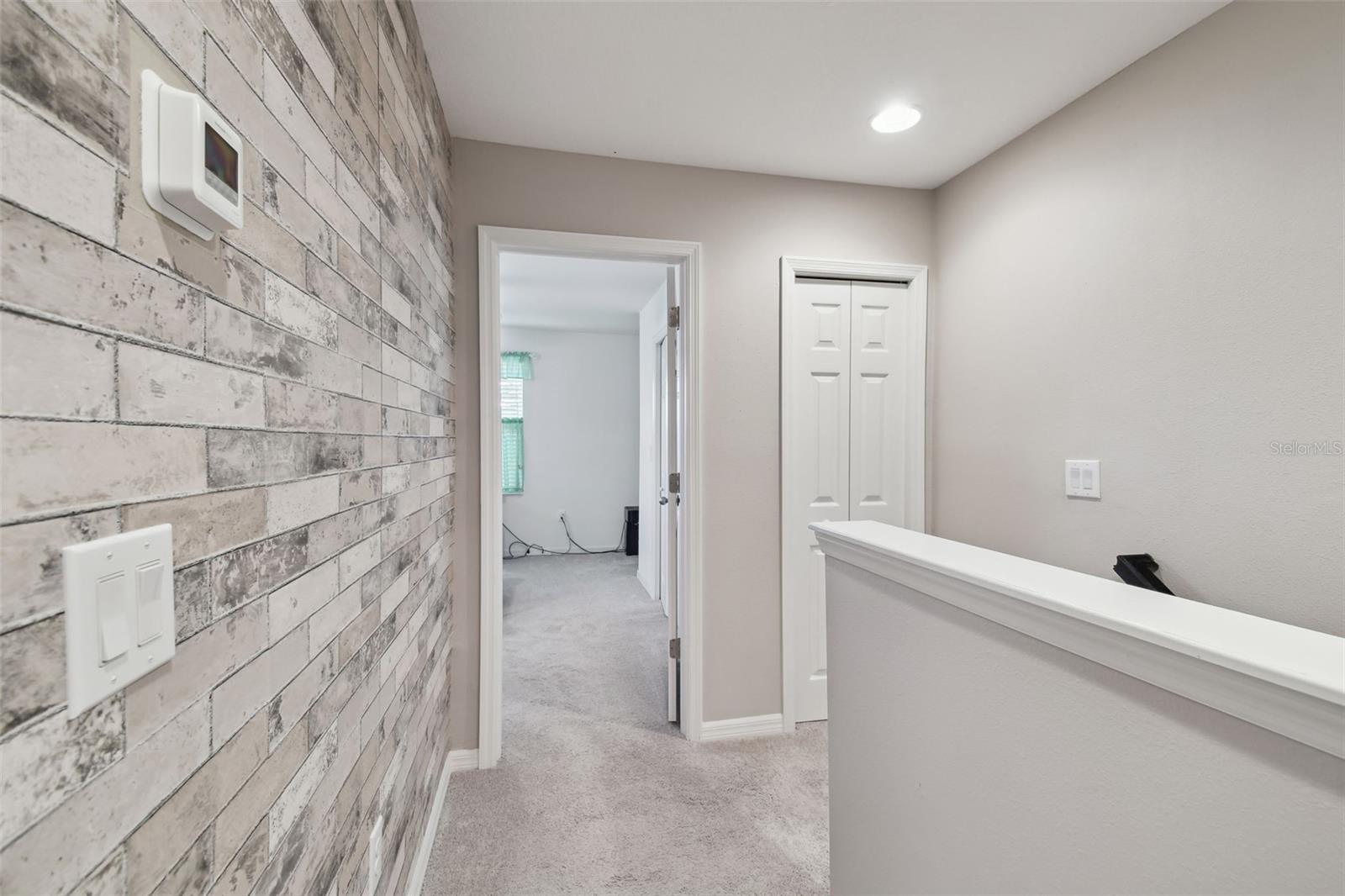 View towards the master bedroom.  Storage closet also at the top of the stairs.