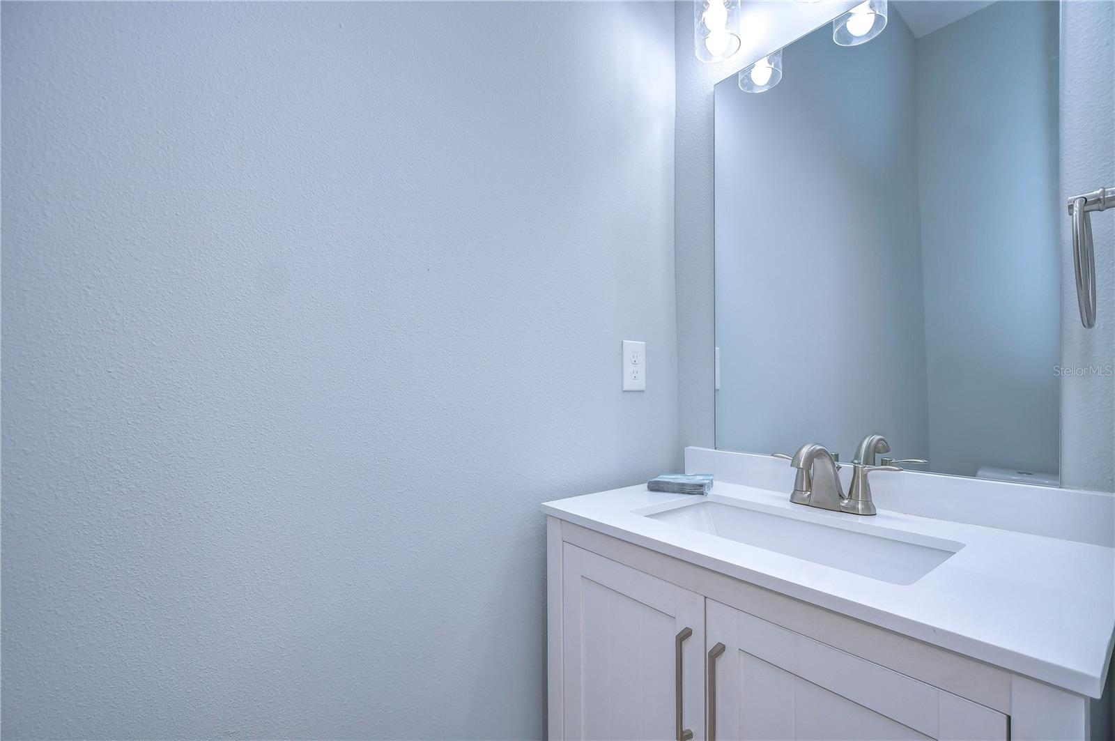 The downstairs powder room has a full vanity!