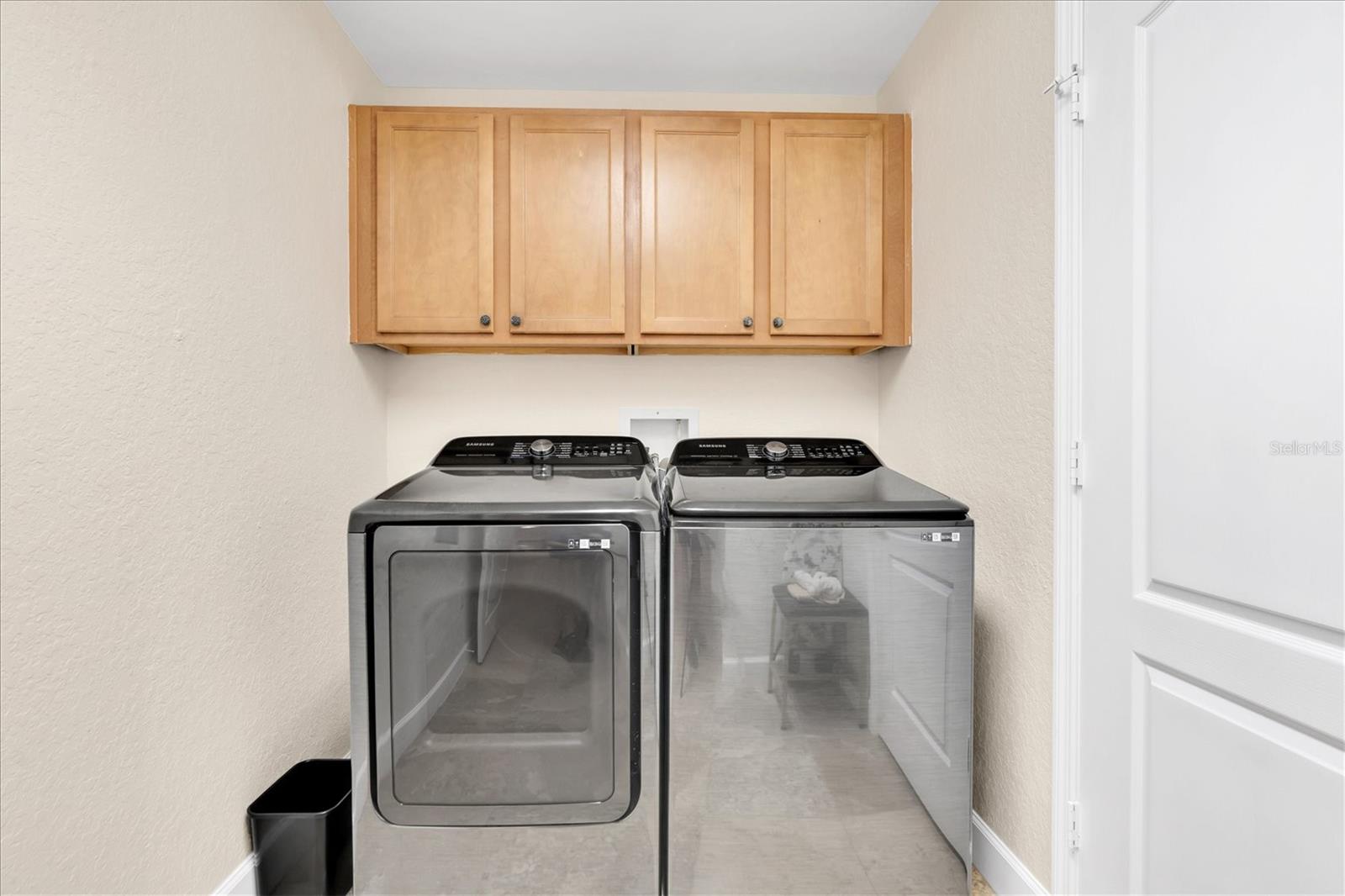 Inside laundry with additional storage closet.