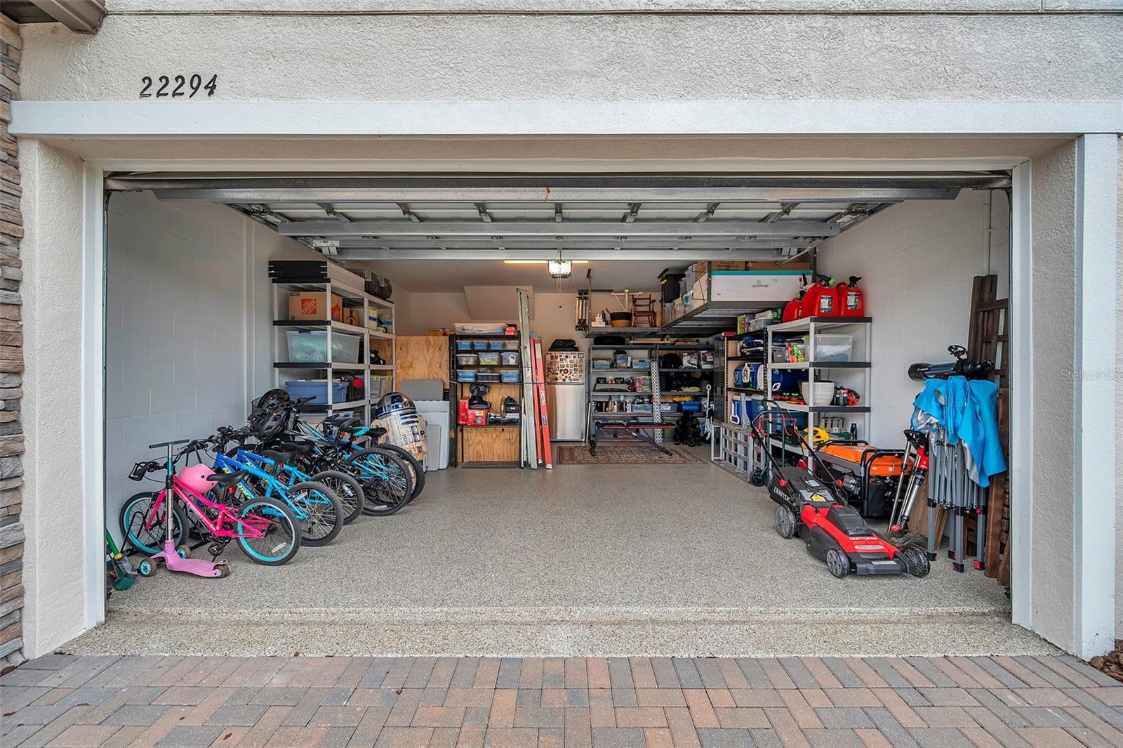 Garage with epoxy flooring and overhead storage racks