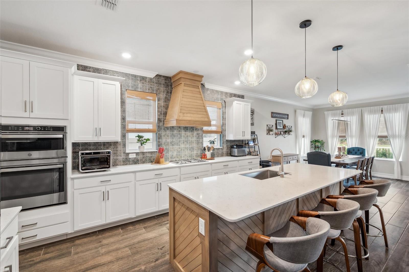 Kitchen with custom woodwork on island and hoodvent